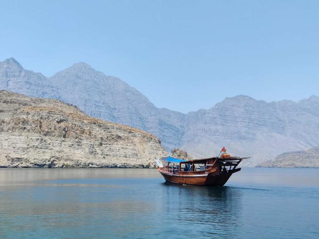 Beautiful boat in the stunning scenery of Musandam, Oman.