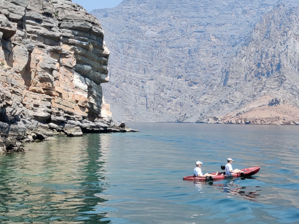 A couple doing kayaking in Musandam, Oman.